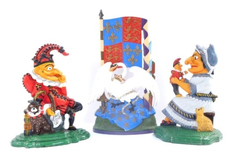 A pair of painted cast iron door stops modeled as Punch & Judy, 29.5cm high, and a further painted cast iron door stop modeled as a Royal Swan and Standard, 42cm high. (3)