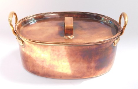 A Victorian copper fish kettle, with cover and brass handles, 38cm wide.