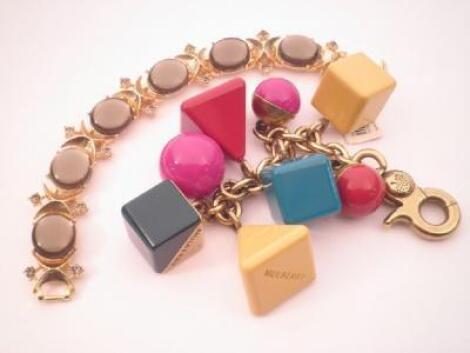 A handbag charm and key fob in the shape of coloured triangles/squares