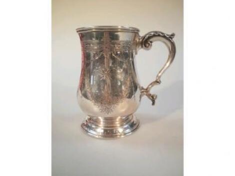 A Victorian silver baluster tankard with scrolled handles engraved with swags