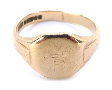 A 9ct gold gentlemans signet ring, with an octagonal ring head bearing rubbed initials, with raised shoulders, ring size T½, 5.6g.