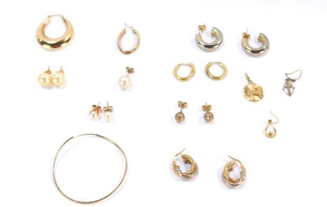 A group of 9ct gold and other earrings, comprising a pair of 9ct gold bicolour hoop earrings, a pair of 9ct gold finish plain design hoop earrings, three loose 9ct gold hoops, 9.5g all in, and various other unmarked studs and drop earrings. (a quantity)