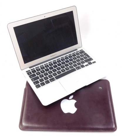 An Apple Macbook, model A1370 with charger and carry sleeve, sold for parts and spares only. Keyboard and mouse broken, and active faults on PC, serial no. C02G4GQUDJYK. (AF)
