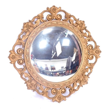 A gilt scroll framed convex wall mirror, 86cm x 82cm.