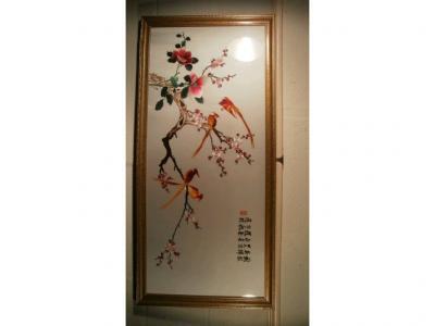 A Chinese silk embroidered picture depicting birds on a cherry blossom