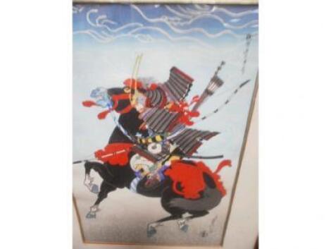 A Japanese wood block print depicting a warrior on horseback