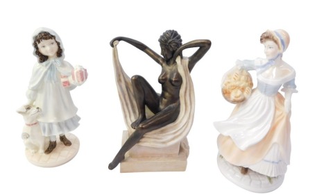 Three figures, comprising a Royal Worcester Bakers Wife, limited edition number 1852 of 5,000, 21cm high, and a Coalport lady a present for Grandma limited edition number 1092 of 5,000, 19cm high, and a modern Deco style figure of a nude lady, 20cm high. 