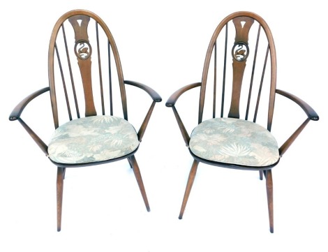 Two Ercol armchairs, each with a carved swan splat, 100cm high.