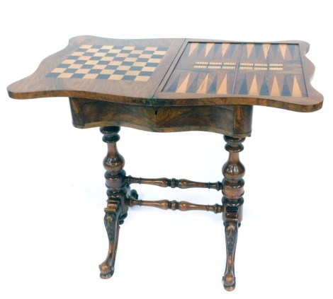 A Victorian figured walnut games table, with two fold folding shaped top, on H frame base, with out splayed legs, 70cm high, 54cm wide, 40cm deep.