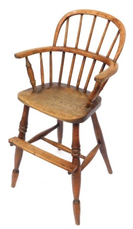 A 19thC ash and elm child's Windsor high chair, with stick back and a foot rest, 92cm high, 42cm wide, 30cm deep.