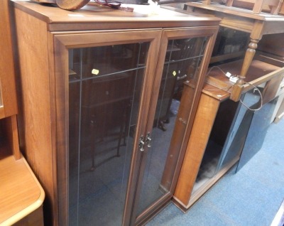 Two display cabinets, comprising a tall display cabinet bookcase and a low bookcase and cupboard. (2)