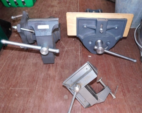 Three various bench vices.