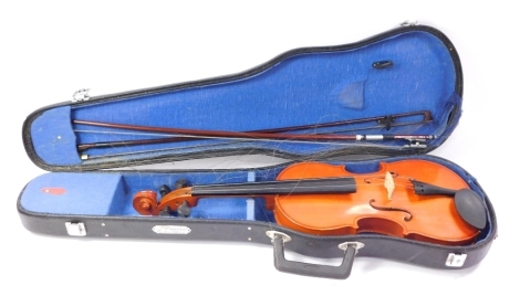 A two piece Chinese violin, with label and reference number NV005, and two bows in fitted case.