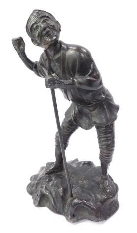 A Japanese spelter figure of a fisherman, perched on rock with blackened finish, 28cm high.