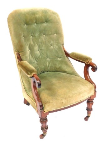 A Victorian mahogany button back armchair, with green velvet upholstery, on turned legs terminating in castors, 102cm high.