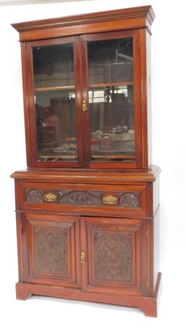 An Edwardian mahogany secretaire bookcase, the bookcase top above a sideboard base with fitted drawer and two cupboards, 270cm high, 115cm wide, 52cm deep.