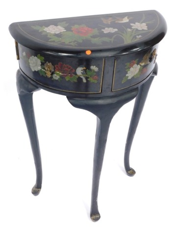 A continental demi lune side cabinet, with black lacquer decoration of flowers and birds, with two drawers, on cabriole legs, 81cm high, 52cm wide, 27cm deep.