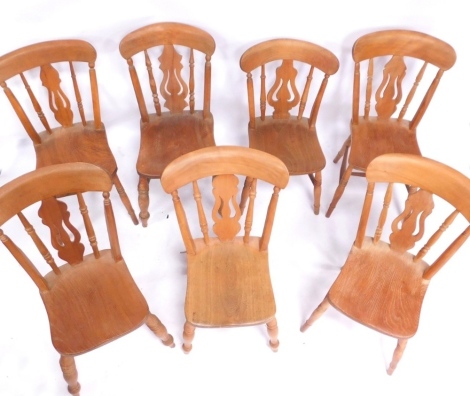 A matched set of seven beech kitchen chairs, each with a harp shaped back. (7)