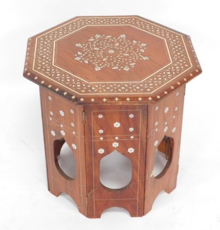 An Eastern inspired hardwood and mother of pearl and bone inlaid octagonal table, 40cm high, the top 37cm x 37cm.