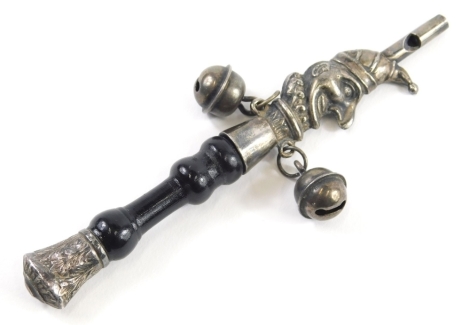 An Edwardian Mr. Punch child's rattle, with turned ebonised stem, whistle top and white metal body unmarked, 12cm high.