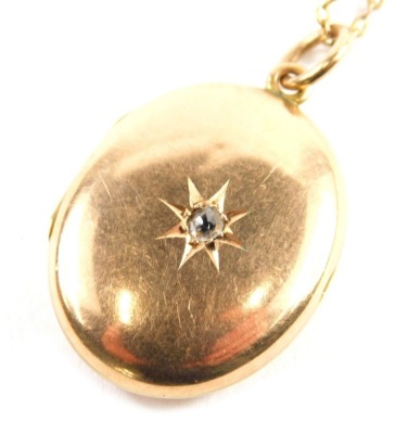 A 15ct gold locket, 3cm high, on a slender link chain, with plain interior, 7g all in.