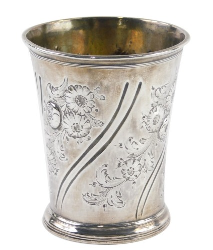 A Queen Anne silver beaker, probably John Conaty, the tapering body repousse decorated with flowers, with further decoration of scrolls on a circular foot, Newcastle 1703, 10cm high, 5.1oz.