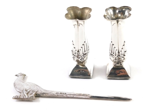 An Elizabeth II silver paper knife, with pheasant handle, London probably 1980, 15cm long, 3oz, and a pair of floral specimen vases on weighted bases. (3)