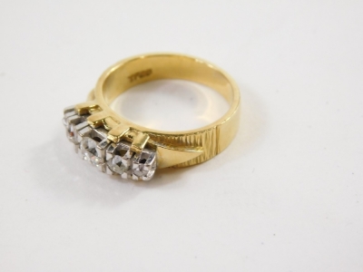 A dress ring, claw set with five graduated diamonds, probably in platinum, on an elaborate shank, yellow metal marked 18ct, size N. - 2