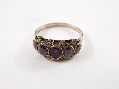 An early 20thC five stone dress ring, with five graduated purple stones, in an elaborate setting, unmarked, size K-L. (boxed) - 2