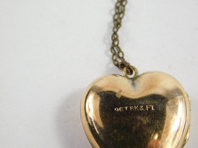 A 9ct gold heart shaped locket, 2cm high, 5.7g, attached to a plated slender link chain, a flapper style necklace and a gold plated bracelet. (a quantity) - 3