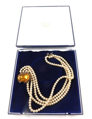 A synthetic pearl choker, the chunky design clasp, with orange paste stones, and outer border on four strap strand, 36cm long, boxed.