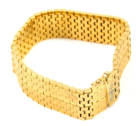 An eastern gold plated bracelet, with meshwork body, bearing marks 0.750, 20cm long.