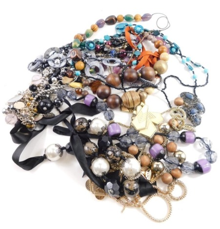 A group of modern costume jewellery, purple stone elongated necklace, ribbon tie necklaces, faux pearls, etc. (a quantity)