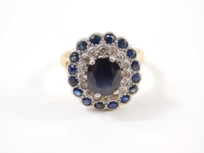 An 18ct diamond and sapphire dress ring, with a stepped floral setting on pierced shank, claw set with a central oval stone, size N-O, 6.3g all in. - 2