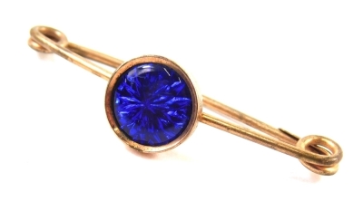 An 20thC pin brooch, centred with a circular blue section on a gold mount, with plated pin back, 5cm wide.