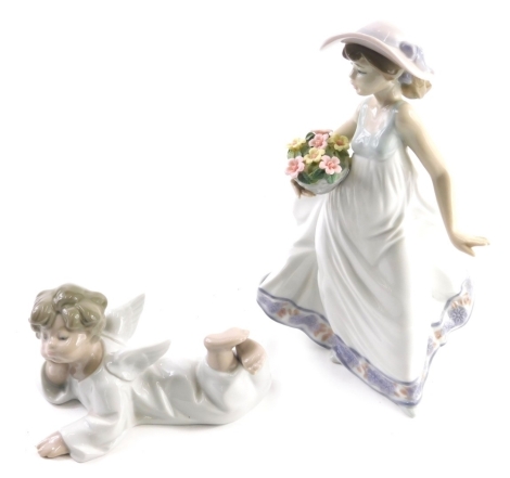 A 20thC Lladro figure of a lady holding a basket, number 5790, and another of a recumbent angel, printed marks beneath. (2)