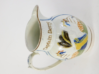 An early 19thC Prattware pearlware Admiral Nelson and Captain Berry jug, raised with flagship and a profile of Nelson with acanthus leaf handle, predominantly in orange, yellow and brown, on a circular foot, 21cm high. - 2