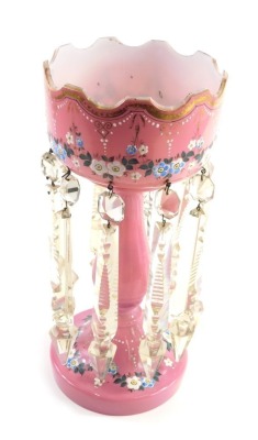 A Victorian pink glass lustre, with castellated top and plain glass dropper, painted with flowers with gilt highlights, 37cm high. Auctioneer Announce: 37cm high. 