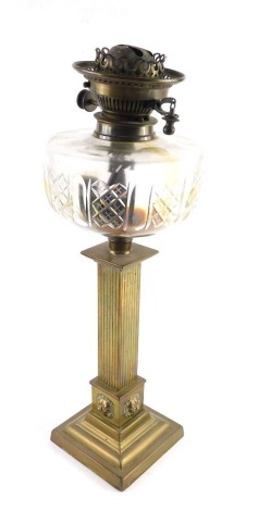 An early 20thC brass oil lamp, with hobnail cut clear glass reservoir and brass mounts, 46cm high.