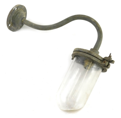 An exterior light fitting, with domed glass shade and S scroll arm with circular fitting and screw holders, 40cm wide.