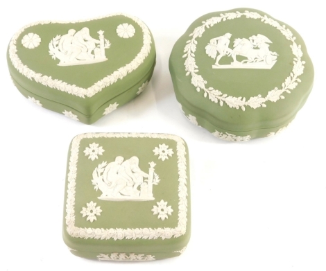 Various Wedgwood green Jasperware, lidded heart shaped box 6cm high, another square with rounded corners and a lidded powder box, decorated with classical figure impressed marks beneath. (3)