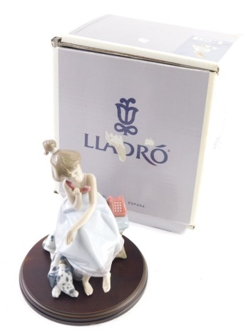 A Lladro figure Chit-Chat, 05466, on wooden stand, boxed, 15cm high.