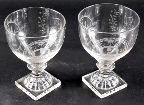 A pair of late 18thC/early 19thC Masonic glass rummers, each engraved with symbols and panels, on a lemon squeezer foot, 13cm high.