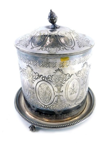 A late 19th/early 20thC silver plated biscuit barrel, with an acorn finial and an all over design of flowers, plants, scrolls, etc., the hinged lid revealing a vacant interior, raised on three claw feet, 20cm high.