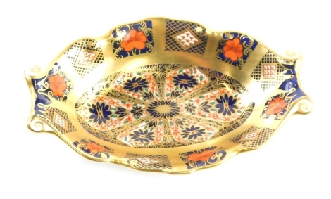 A Royal Crown Derby Imari pattern pin dish, with scroll oval body, number 1128 mark beneath, 14cm wide.