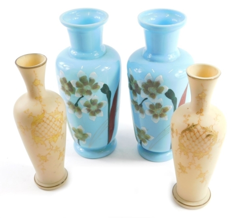 A pair of early 20thC blue glass vases, each with trumpet stems and shouldered bodies, painted with flowers and a further pair of vases. (4)