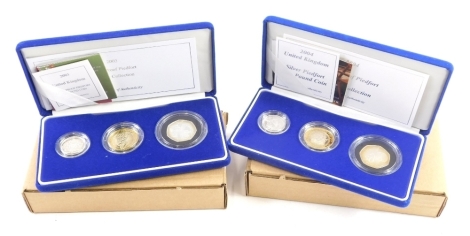 A 2003 United Kingdom silver Piedfort three coin set, and another 2004, each with paperwork, box and outer packaging.