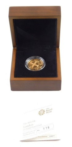 A Royal Mint 2010 UK London one pound gold proof coin, number 116, in outer box with paperwork.