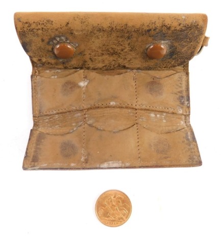 A George V gold half sovereign, 1911, in pig skin coin case, 9cm wide.