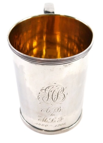 A William IV silver and silver gilt mug, etched initialled and dated 1800-1908, with shaped handle, Sheffield 1831, 9cm high, 3oz.